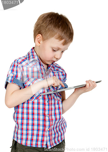 Image of A boy in a plaid shirt with a tablet computer