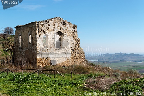 Image of Farmhouse ruin among rural landscape