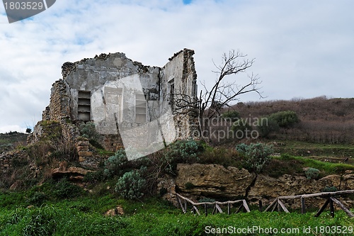 Image of Farmhouse ruin among rural landscape