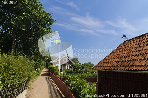 Image of Narrow street and red cottages in Sweden