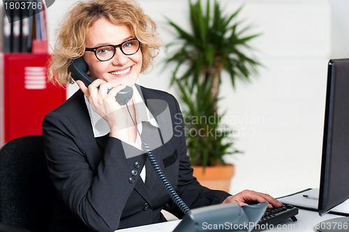 Image of Front desk lady attending clients call