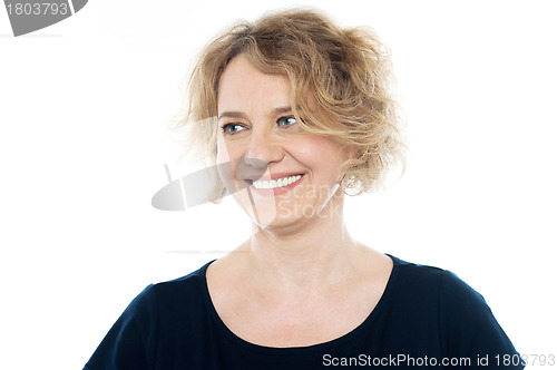 Image of Beautiful happy woman looking away