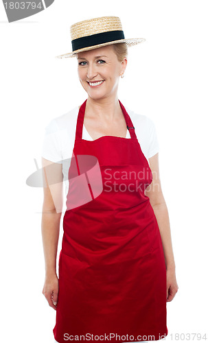 Image of Trendy middle aged cheerful cook wearing hat