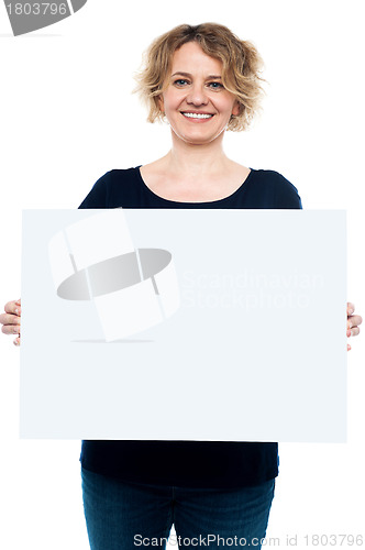 Image of Casual lady displaying blank white billboard