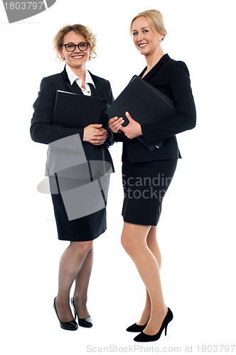 Image of Aged businesswomen posing with documents