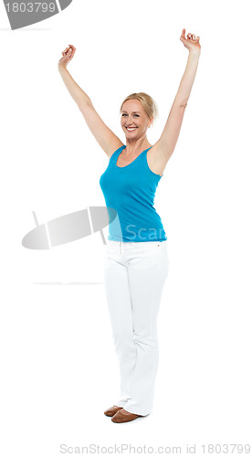 Image of Successful woman posing with raised arms