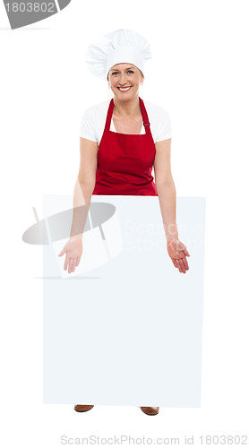 Image of Beautiful chef showing blank white board