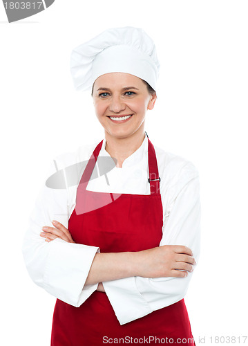 Image of Portrait of smiling middle aged cook in uniform