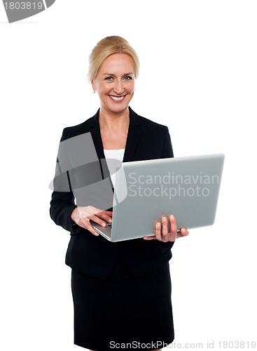 Image of Corporate woman holding laptop