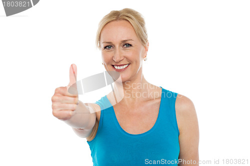 Image of Smiling aged woman showing thumbs up