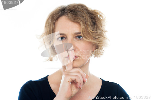Image of Woman gesturing silence, closeup shot