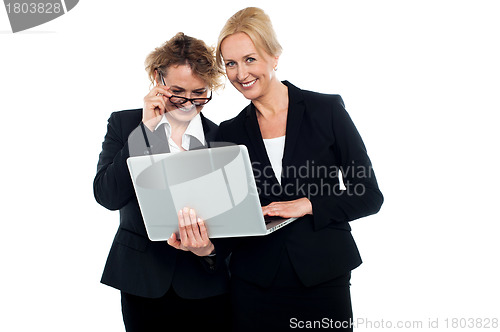 Image of Business friends enjoying video on laptop