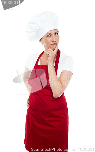 Image of Thoughtful female chef looking away