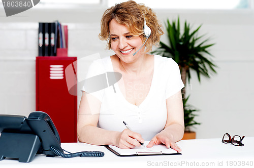 Image of Cheerful customer support executive at work