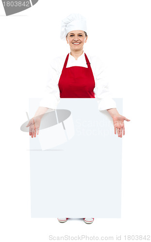 Image of Female cook showing white blank ad board