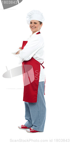Image of Side view of confident middle aged female chef