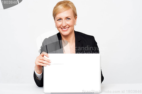 Image of Secretary holding laptop flap, about to close