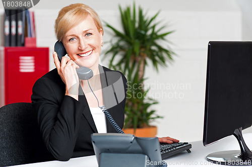 Image of Secretary talking on phone with client