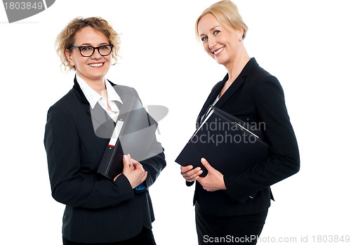 Image of Happy middle aged business females holding files