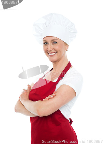 Image of Happy middle aged woman with crossed hands