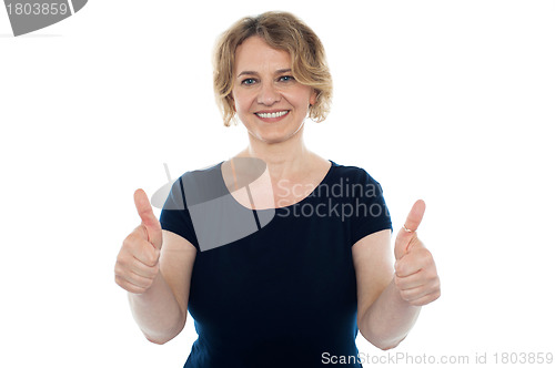 Image of Cheerful casual woman showing double thumbs up