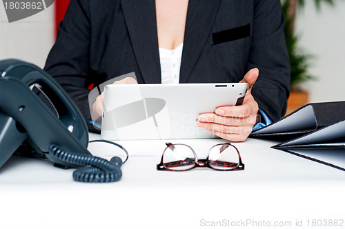 Image of Cropped image of woman holding tablet device