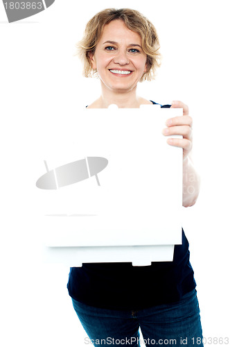 Image of Casual woman holding open pizza box