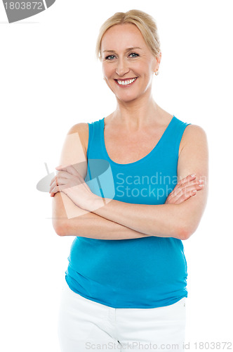Image of Beautiful woman standing with arms crossed