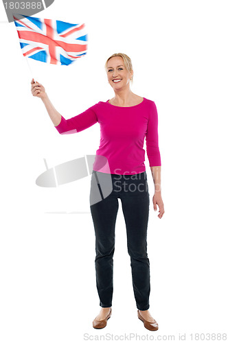 Image of Aged patriotic lady waving United Kingdom flag