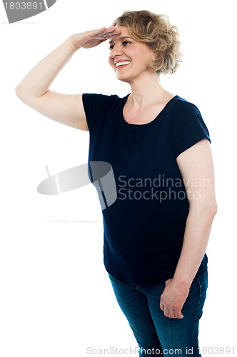 Image of Lady looking for someone with hand on forehead