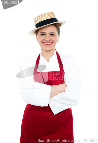 Image of Lady cook in white red uniform wearing hat