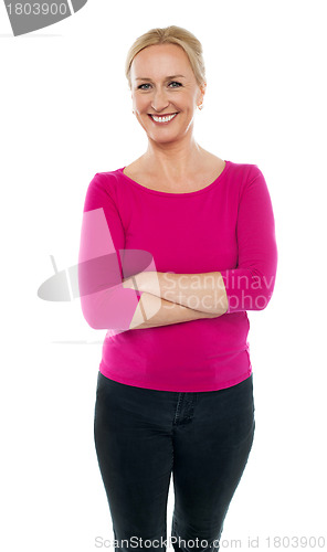 Image of Confident woman standing with arms crossed