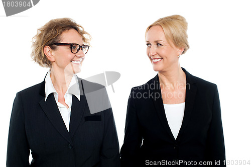 Image of Aged corporate women looking at each other