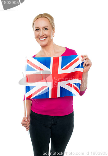 Image of Cheerful female supporter holding national flag