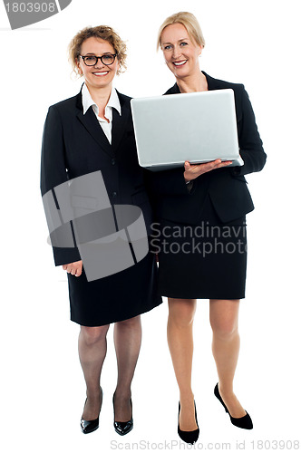 Image of Senior businesswomen posing with laptop