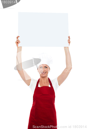 Image of Chef holding advertising board over her head