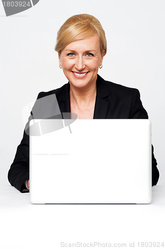 Image of Aged corporate lady working on a laptop