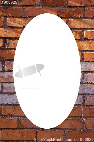 Image of Red brick wall background and white oval in center 