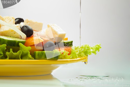 Image of Greek Salad with oil flowing