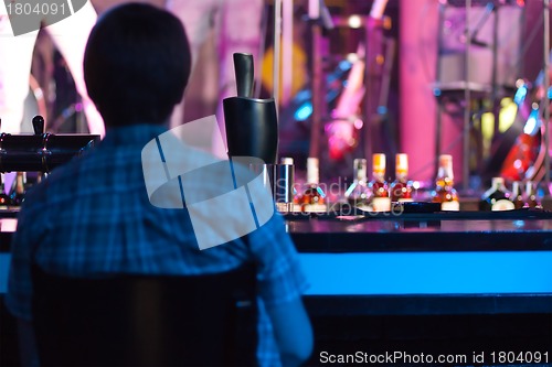 Image of Man sitting in a bar