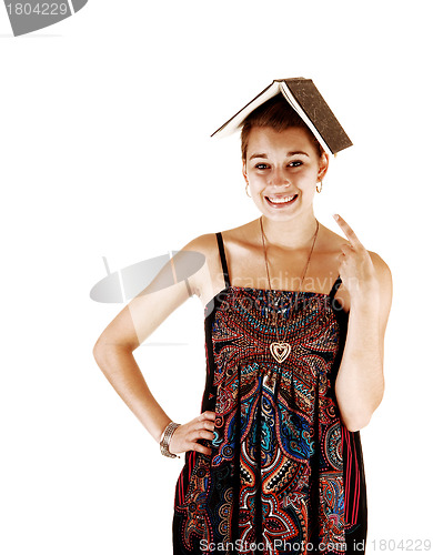 Image of Girl with book on head.