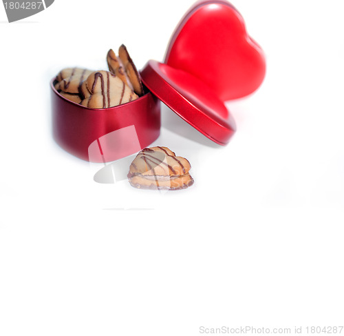 Image of heart shaped cream cookies on red heart metal box