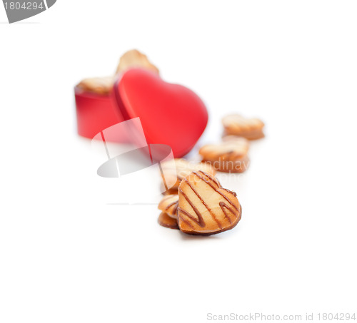 Image of heart shaped cream cookies on red heart metal box