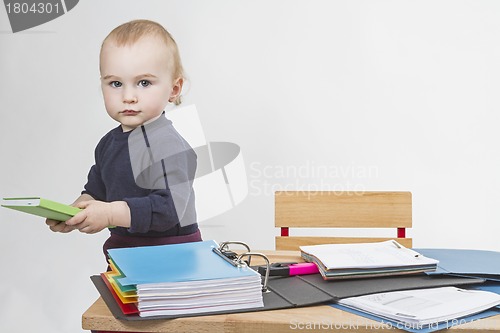 Image of young child at writing desk