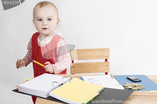 Image of young child at writing desk