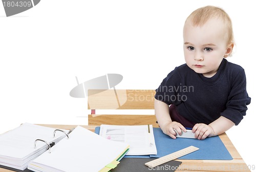 Image of young child at writing desk