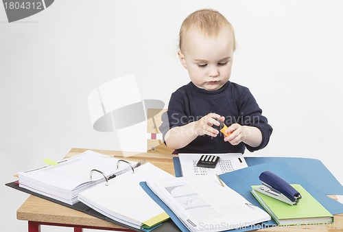 Image of young child at writing desk