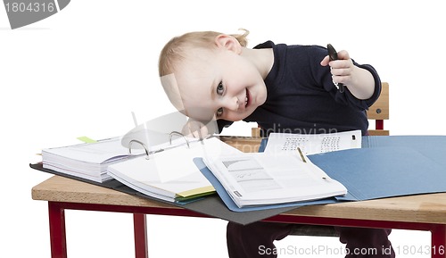 Image of young child at writing desk