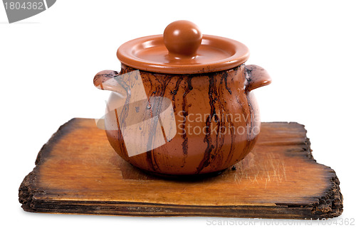 Image of Dirty ceramic pot on old kitchen board