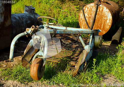 Image of Retro rusty potato digging agricultural machinery 